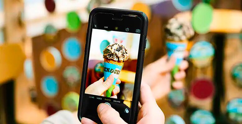 taking picture of ice cream cone with cell phone